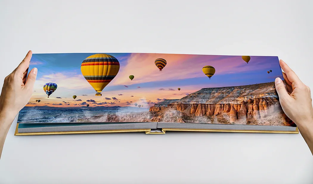 A layflat photo book open on a panoramic spread