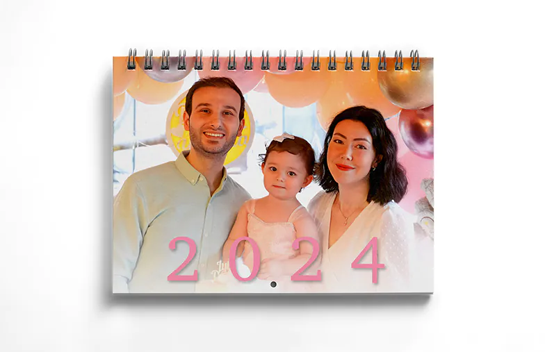 Girlfriend photo on personalised wall calendar hung up in living room