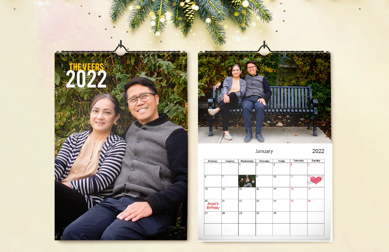 Woman writing on A4 customised wall calendar by printerpix with christmas theme photo