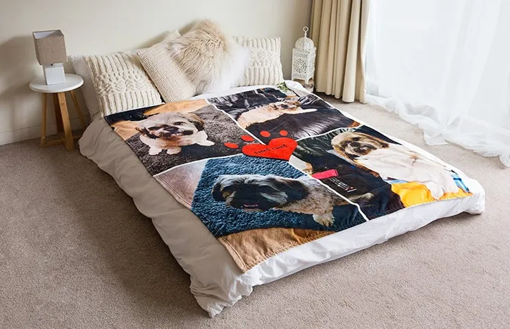 A soft Printerpix mink touch blanket with a dog collage design is spread across a bed.