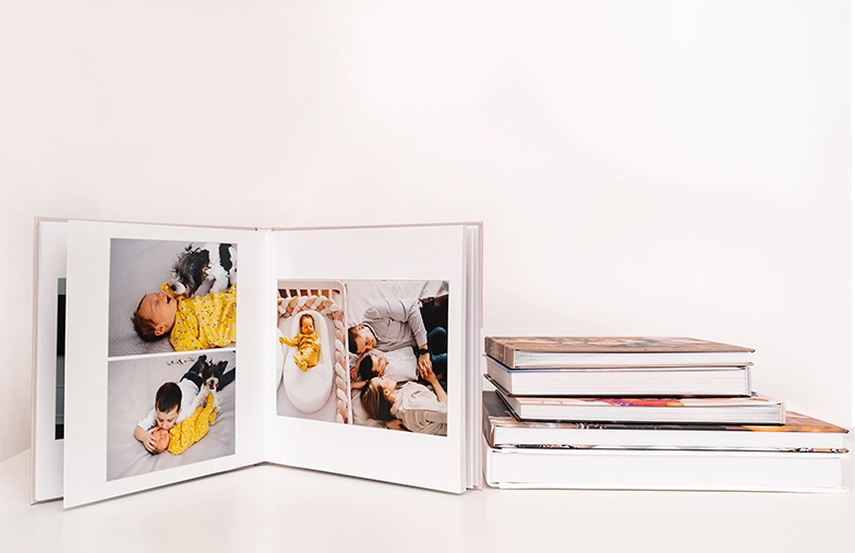 Pet and woman looking at personalised family photo book with custom design