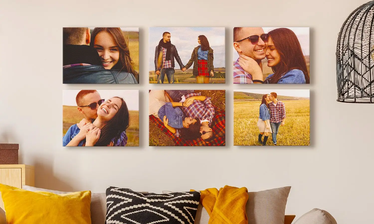 A man has his arm over the shoulder of a woman as they sit in the bath facing a red wall with 3 canvas prints on