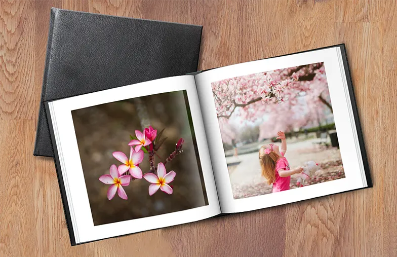 Couple look at leather cover custom photo book made by Printerpix