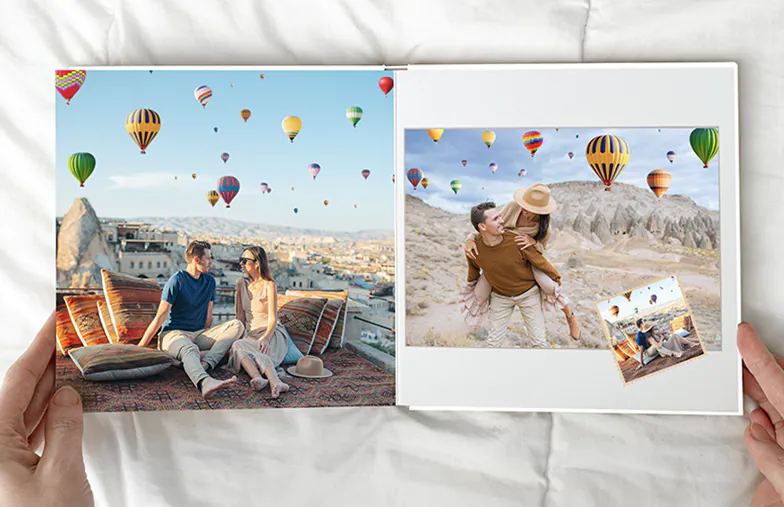 Pet and woman looking at personalised family photo book with custom design