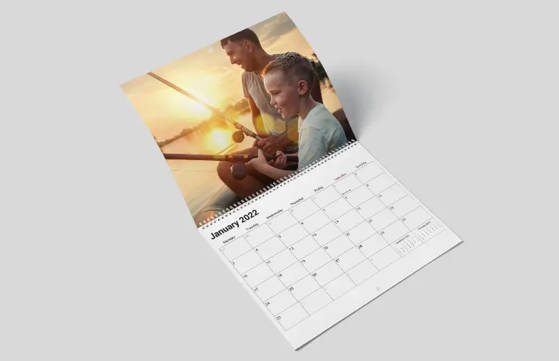 Dog photos on custom design photo calendar hung up on wall